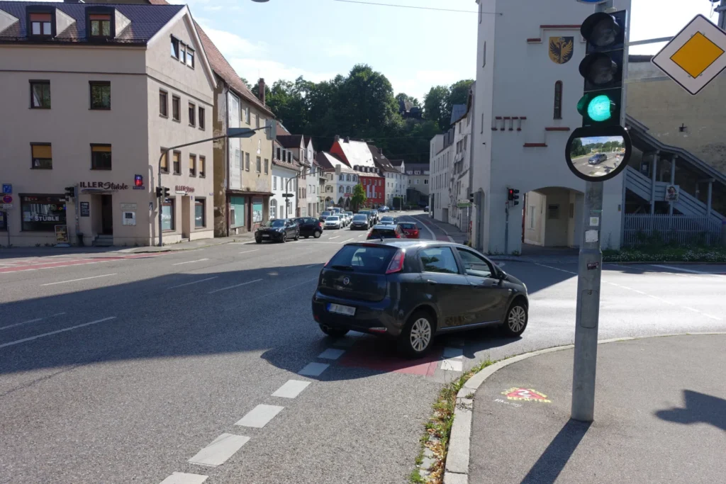 Rechts abbiegendes Auto, das über Radweg fährt